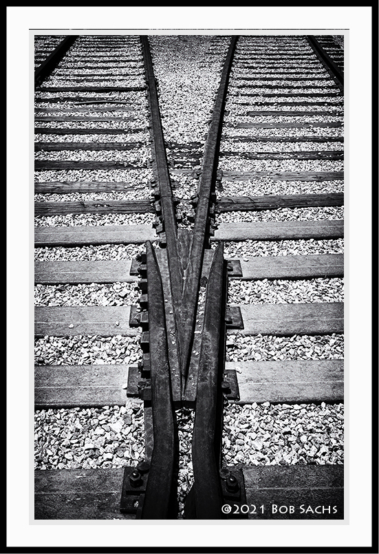 Two tracks joining as one in black and white.
